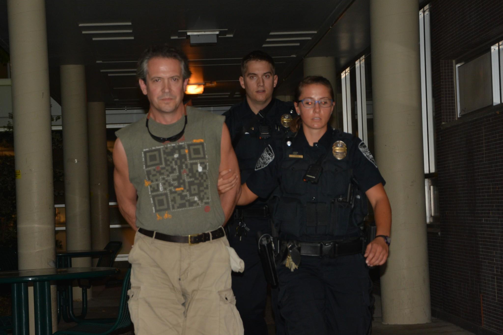 CSUPD escort man from Morgan Library Tuesday evening. (Photo by: Abbie Parr).