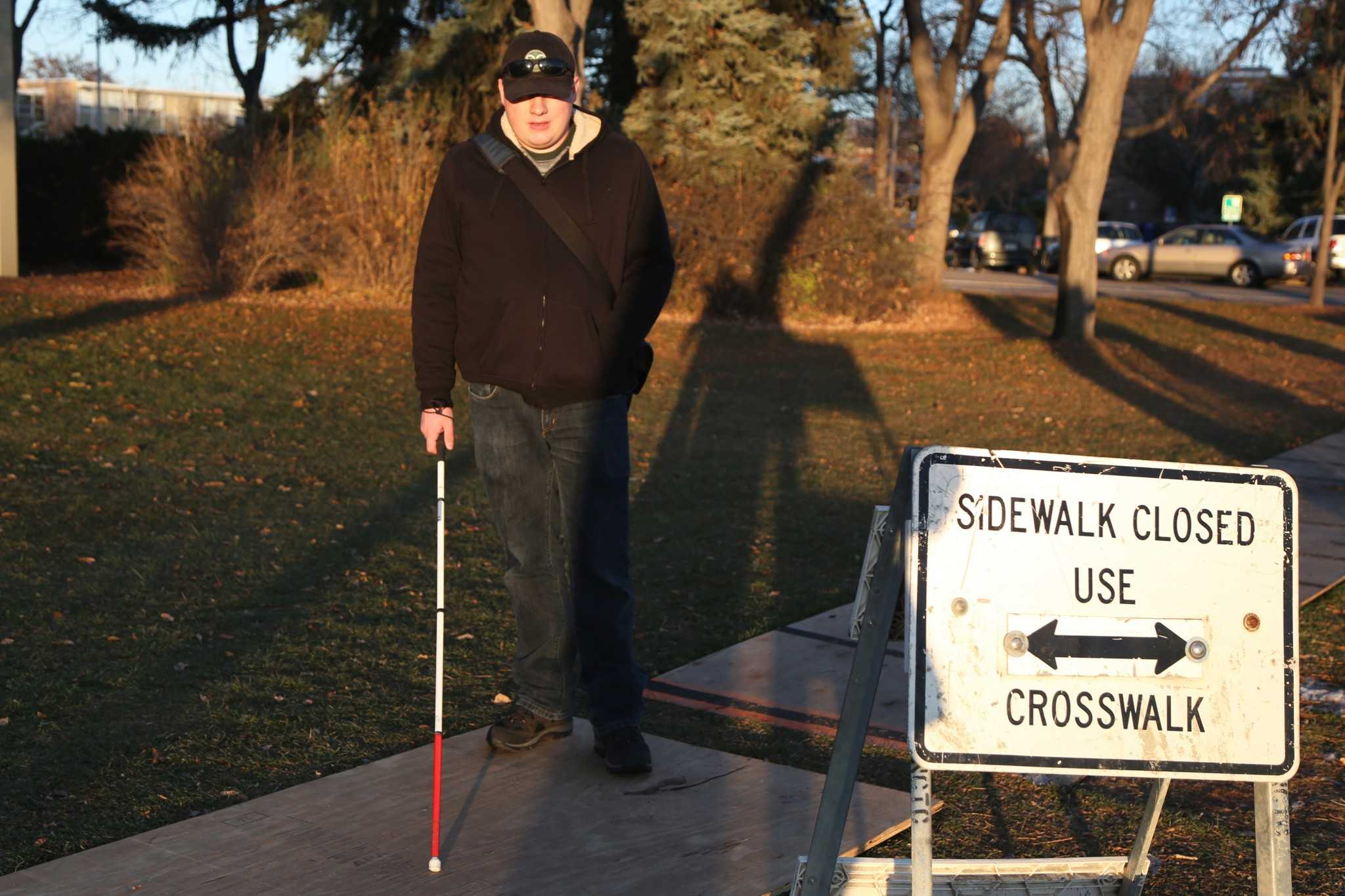 The construction on Pitkin street closed two sidewalks, leaving makeshift pathways off to the side. Joe Tiner explains how this is difficult for some people to walk through leaving them frustrated. (Photo credit: Amanda _).